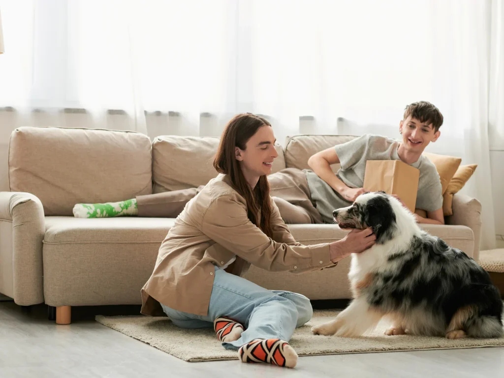 Happy people relaxing with their dog in a comfortable home with efficient HVAC climate control.