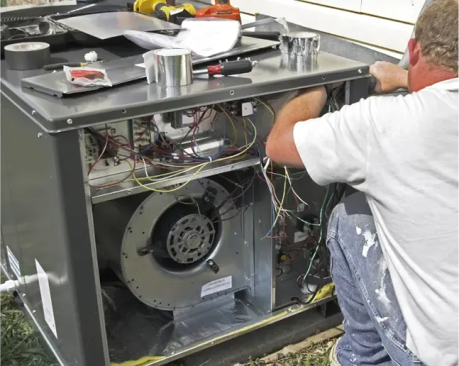 HVAC technician performing maintenance on a commercial outdoor unit.