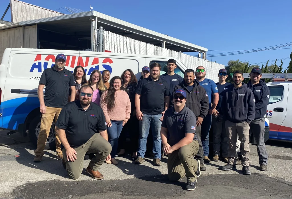 Aquinas HVAC Santa Clara team standing in front of company service vans.