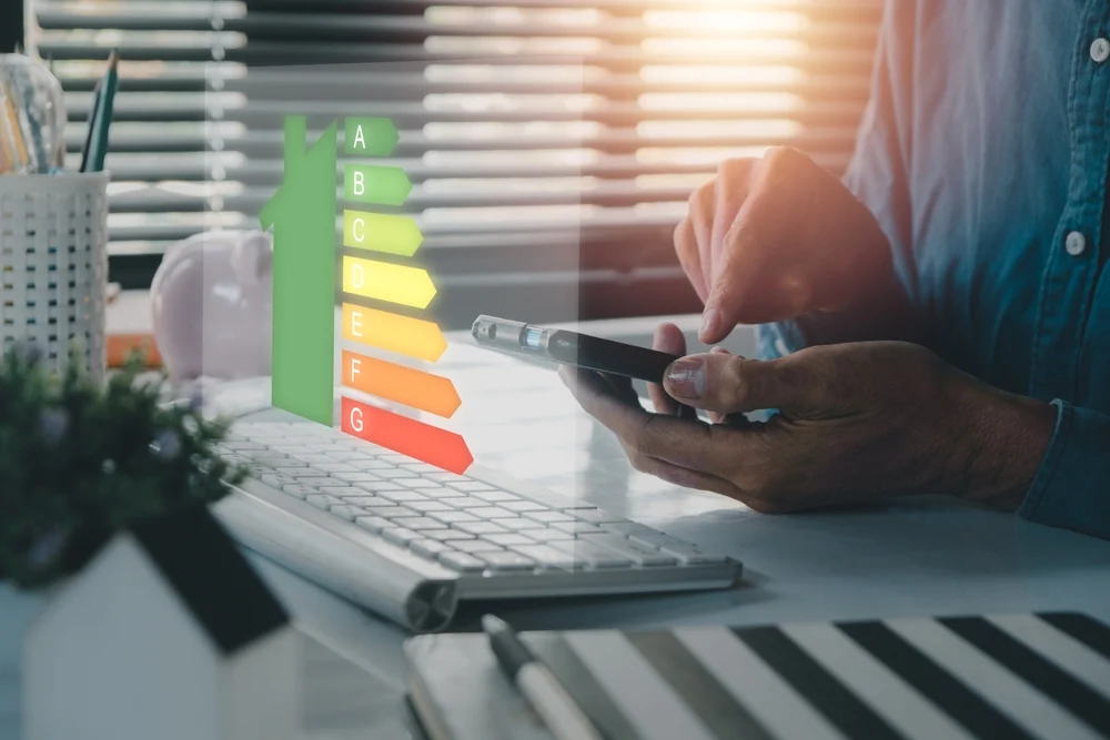 Business professional reviewing commercial HVAC energy efficiency ratings on a mobile device.