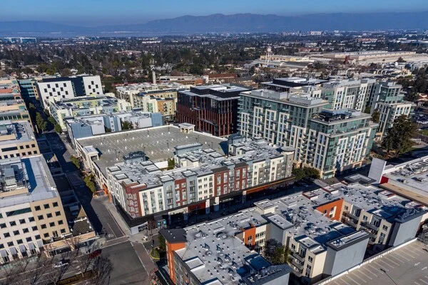 Aerial view of a modern mixed-use development in Sunnyvale, California, featuring retail, office, and residential buildings suitable for commercial HVAC services.