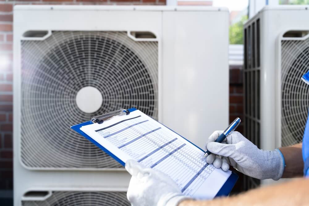 Technician reviewing HVAC equipment for a commercial property contingency plan in San Diego